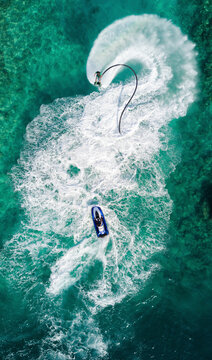 Aerial view of a flyboard water-sporting in a lagoon, Maafushi, Kaafu atoll, Maldives.
