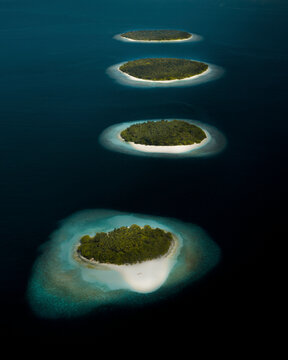 Aerial view of the famous island chain consisting of four islands, Undhoodhoo, Funadhoo, Hulhudhoo and Gemendhoo, Baa atoll, Maldives.