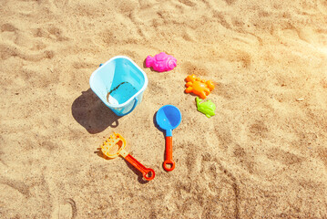 Children's toys for sand on the beach, bucket, scoops and molds. A child at sea.