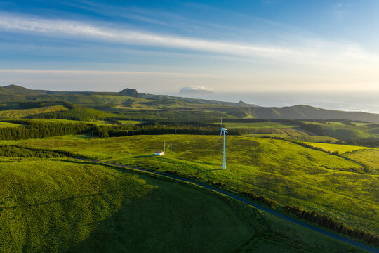 Aerial view of wind turbines in countryside at sunset on Ilha das Flores, Azores islands, Portugal.