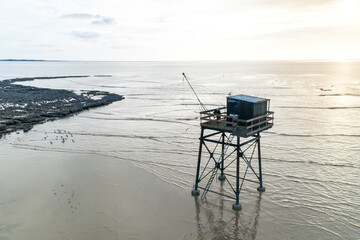 Aerial view of a Fisheman's cabin on stilts with fishing nest during low tide in Pointe de la Fumee, Fouras, Moeze-Oleron Nature Reserve, Charente Maritime, France.