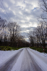 Fototapeta premium Beautiful Winter landscape and old house with road covered by snow