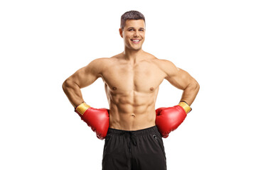 Shirtless male boxer with gloves smiling at camera