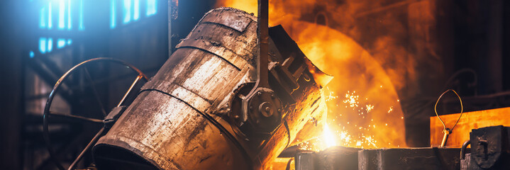 Heavy metallurgy horizontal banner background. Iron cast process. Liquid molten metal pouring into...