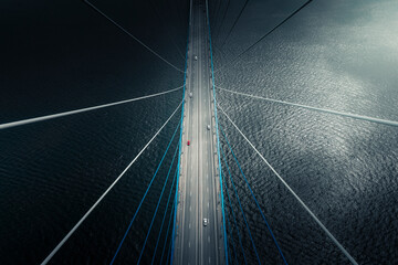 Aerial view of vehicle driving on Russkiy Bridge crossing the bay in Vladivostok, Russia.