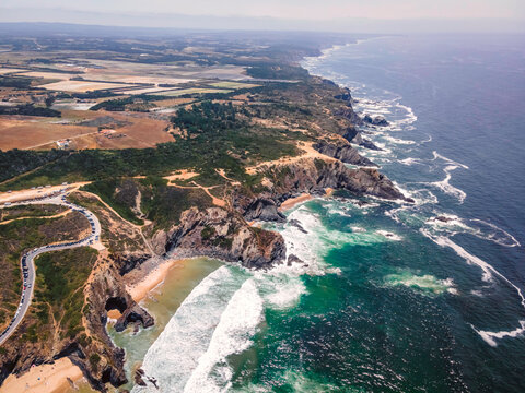 Aerial view of beautiful wild cliff coastline near Odeceixe, Faro, Portugal.