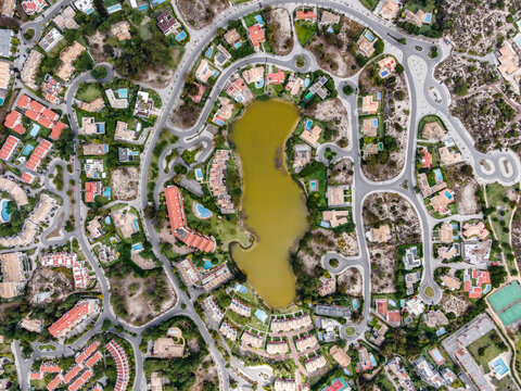 Aerial view of an exclusive luxury village with expensive villas and hotels on Troia Peninsula along the beach with artificial lake, Setubal, Portugal.