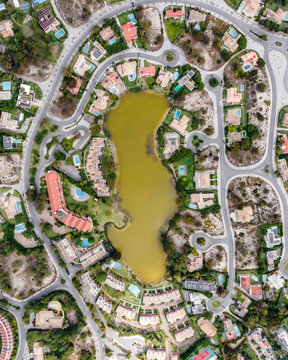 Aerial view of an exclusive luxury village with expensive villas and hotels on Troia Peninsula along the beach with artificial lake, Setubal, Portugal.