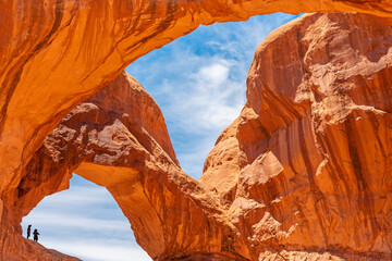 Double Arch with silhouette of two people, Arches national park, Utah, USA.