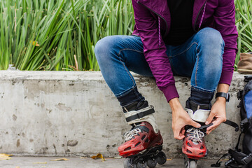 unrecognizable man putting his skates on