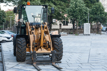 Selective blur on a yellow forklift truck, industrial big size, on display in an outdoor construction site used at moving , loading and unloading construction materials. ..