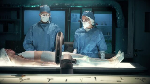 Team of surgeons perform a delicate operation using modern medical full body holographic scanner on female patient laying on futuristic bed showing injured spinal cord. Augmented Reality Technology.