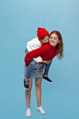 Obraz premium Full length photo women in wide sweater and modern sneakers hugs and smiling on isolated background. Modern girls in bright clothes posing..