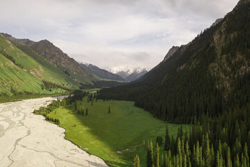 Fototapeta premium River and mountains with white clouds.
