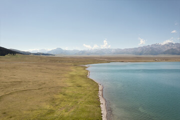 Lake and grassland with a sunny day. Shot in Sayram Lake in Xinjiang, China.