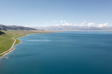 Lake and grassland with a sunny day. Shot in Sayram Lake in Xinjiang, China.