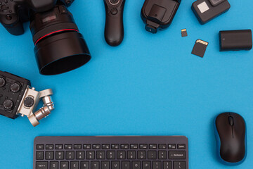 Top View of Photographer's, Videographer's or Video Blogger's Workplace. Digital Gadgets Lying on Blue Table - Flat Lay