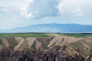 Grassland and mountains in a cloudy day.