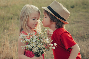 Lovely children. Kids Love story, kiss. Beautiful little couple - boy and girl embracing. Summer...