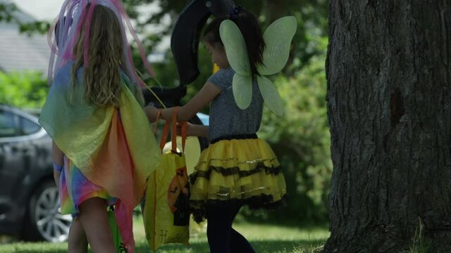 Two girls out trick or treating on halloween slow motion costumes