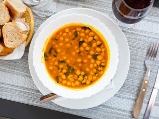 Homemade spicy stew with chickpeas and spinach, vegetarian dinner