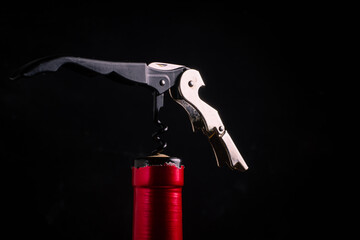 corkscrew and bottle of wine