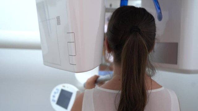 Woman patient in X-ray machine scanner in medical cabinet in hospital. Work place of doctor in clinic. Healthcare