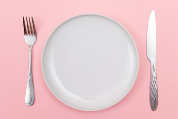 Empty White Ceramic Plate with Fork and Knife on Pink Background - Top View, Flat Lay
