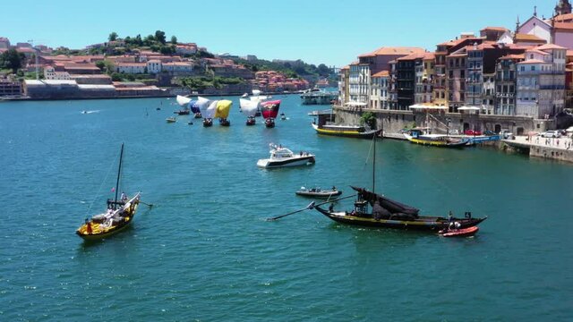 Aerial drone shot of Fonseca Rabelo cargo Boat and Regatta of ships in background during event on Douro River