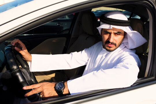 Driving Arab Wearing Kandura Dish Dash. Emirati Man Inside A Car