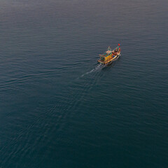 Fototapeta premium Fishing boat returning home in the evening