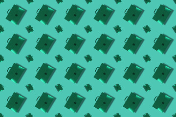 Monochrome composition with Green briefcases with handle on gree