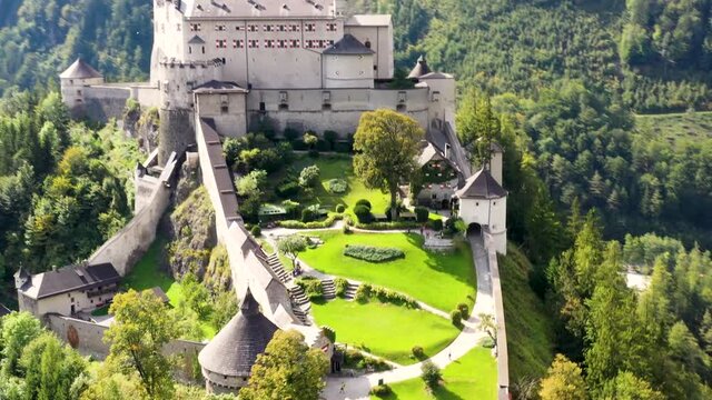 Spectacular aerial view of alpine castle Werfen (Hohenwerfen) near Salzburg, Austrian Alps, Austria, Europe. Medieval rock fortress with spruces. Overlooking the Werfen town in Salzach valley. Summer