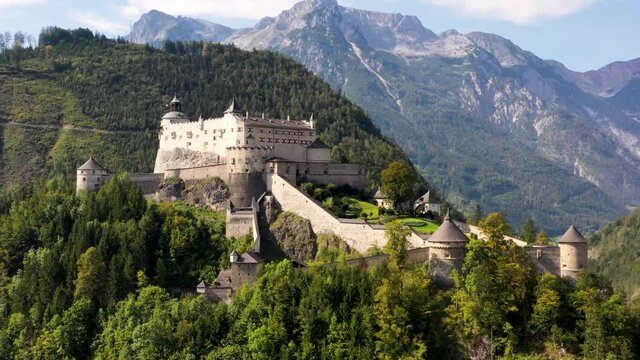 Aerial  view of Hohenwerfen Castle, Austria, Europe. Medieval rock fortress in Alpine mountains with spruces. Overlooking the Werfen town in Salzach valley. Summer.