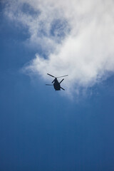 Fototapeta na wymiar 夏の綺麗な青空と飛んでいるヘリコプターの風景