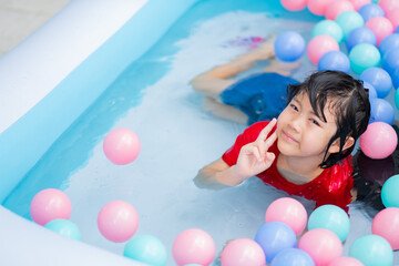 Fototapeta na wymiar kid swimming at the pool, happy time