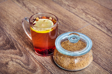 Cup of Healthy Herbal Tea with Dried Fruits, Lemon and Brown Cane Sugar 