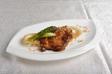 Grilled bbq black pepper pork beef chops steak fried with garlic, onion and asparagus in white background asian banquet menu