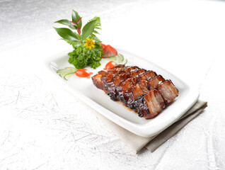 Hong Kong Roasted bbq dark honey sweet pork belly meat char siew in white background asian banquet menu