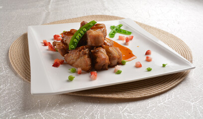 Stir fried dark plum sweet and coffee sauce pork spare ribs meat with almond in white background asian banquet menu