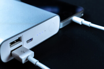Phone power bank. Mobile phone or smartphone battery charging from portable powerbank with white...