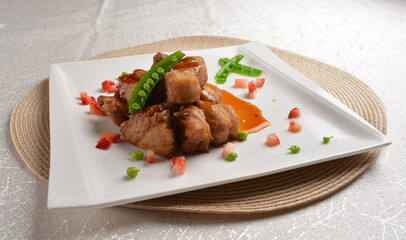 Stir fried dark plum sweet and coffee sauce pork spare ribs meat with almond in white background asian banquet menu