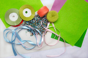 Composition of yarn, beads, threads, ribbons and foam paper