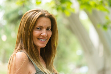 Long hair mature woman smiling looking at camera