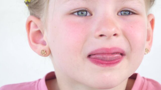 Close up saliva. drool on tongue little girl. The child shows the throat and palate to the doctor. Health concept. Play and stick out your tongue and teeth. Salivation in children.