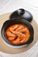 braised cook big fresh tiger prawn with red spicy curry soup in hot clay pot asian halal seafood menu