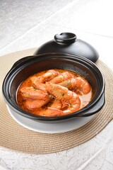 braised cook big fresh tiger prawn with red spicy curry soup in hot clay pot asian halal seafood menu