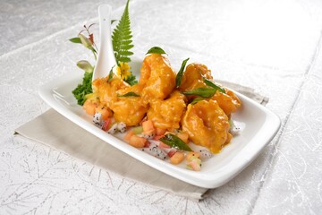 stir fried big tiger prawn seafood with pumpkin salted egg yolk creamy sauce and curry leaf in white background asian halal menu