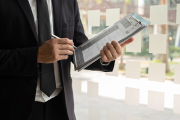 Business people hold a resume for applicants for work interviews about careers and Their personal...