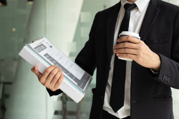 Business people hold a resume for applicants for work interviews about careers and Their personal...